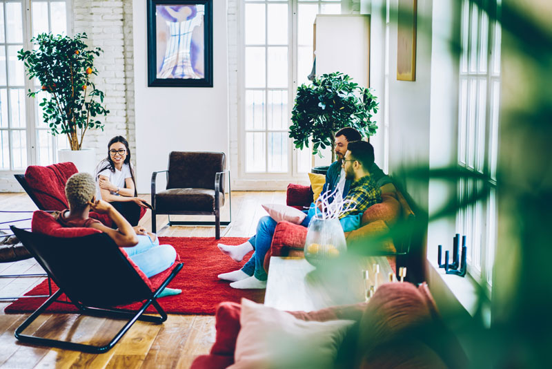 friends enjoying relaxing conversation in airy liv